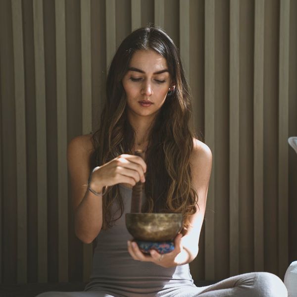 Person sitting peacefully in a calm, focused state, with a lime accent.
